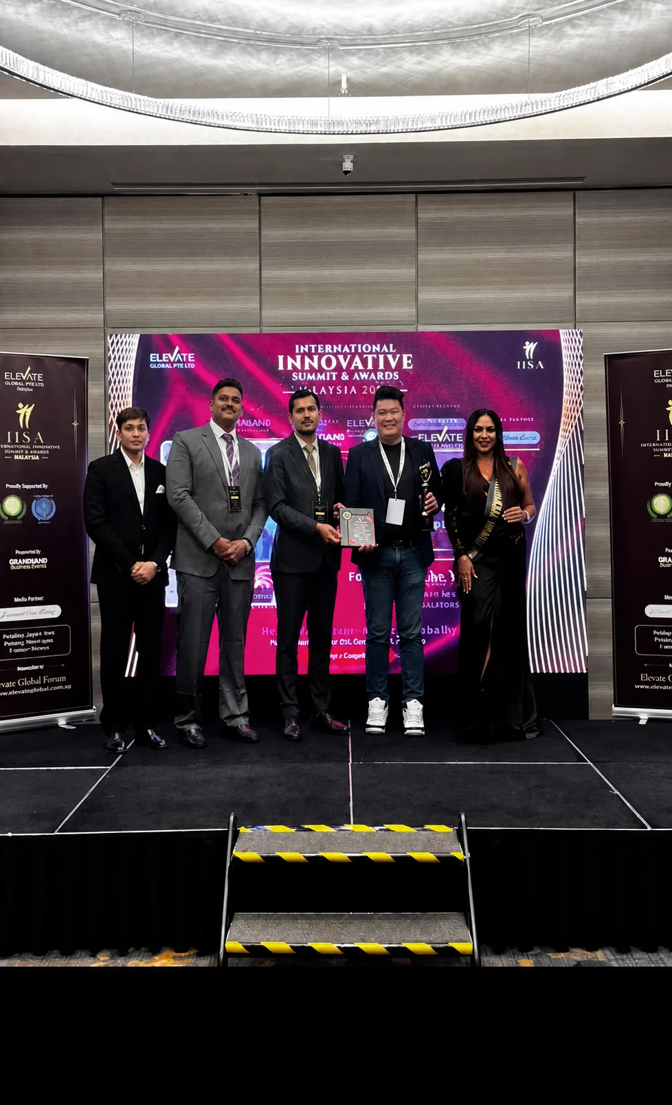 Mr. Joel Tee accepting an award on behalf of Mr. Pankaj Ashri in Kuala Lumpur, Malaysia